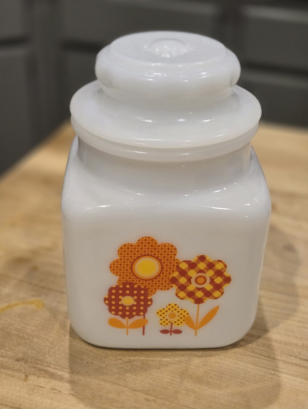 vintage Jeannette milk glass kitchen canister featuring a retro 1970s
